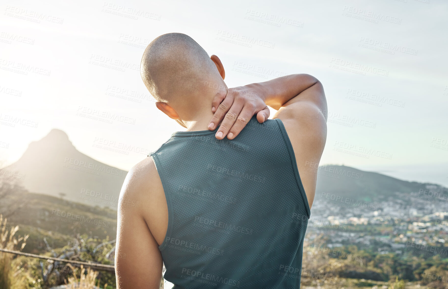 Buy stock photo Shot of a man holding his neck in pain while out for a run