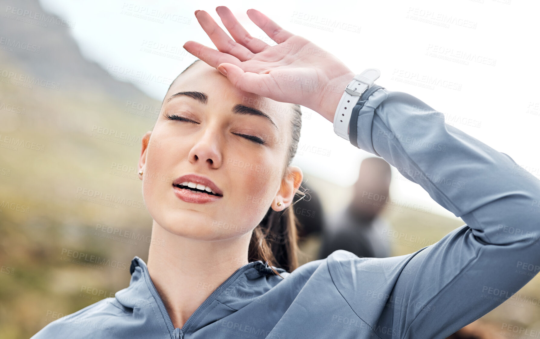 Buy stock photo Shot of a woman looking exhausted while out for a run