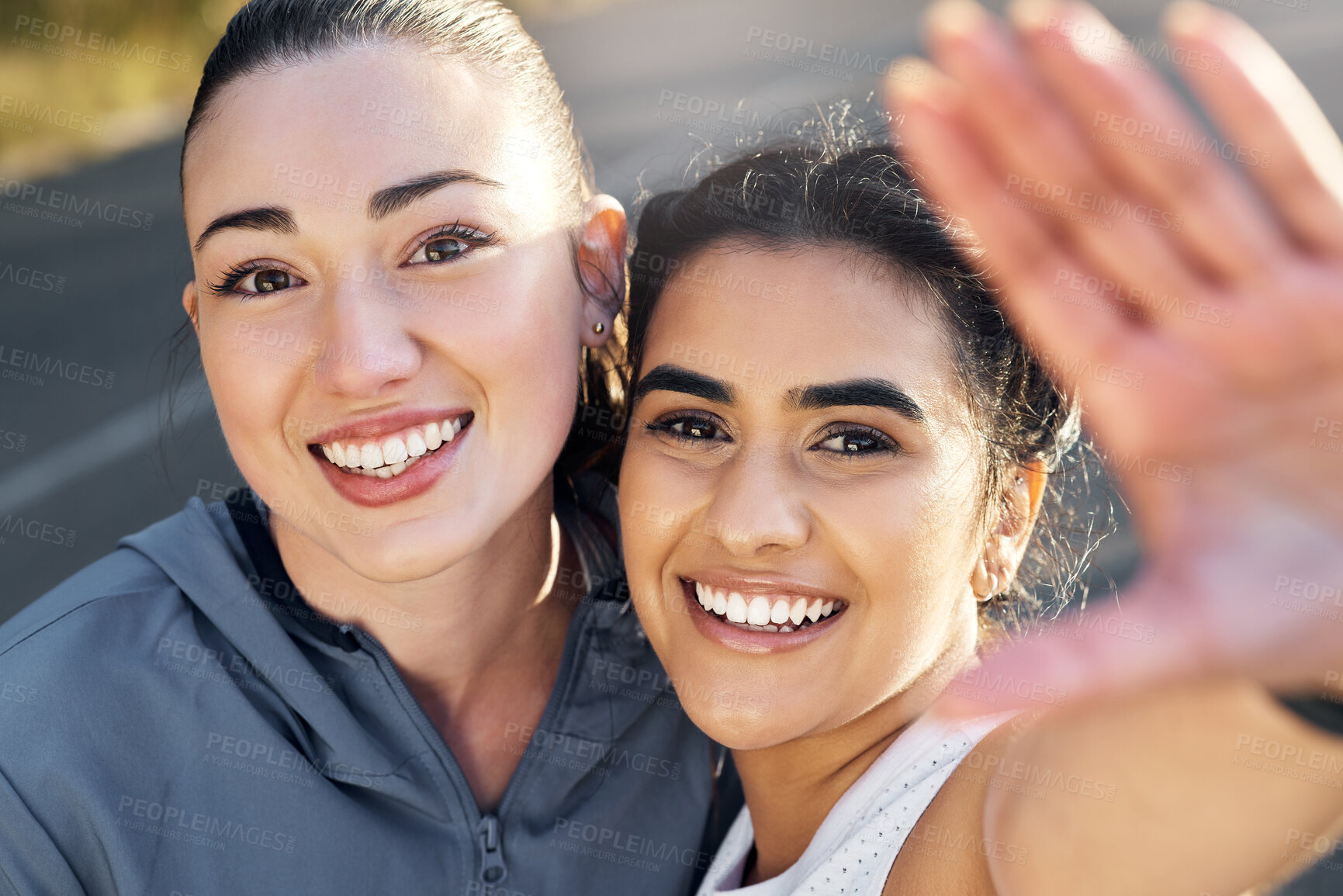 Buy stock photo Shot of two young women out for a run together