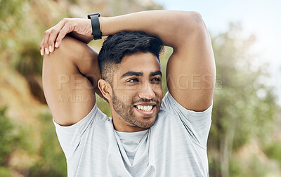 Buy stock photo Shot of an athletic young man stretching outside