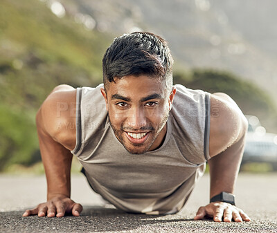 Buy stock photo Shot of an athletic young man doing push-ups outside