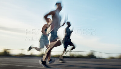 Buy stock photo Blurred shot of three athletic young men running together