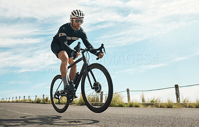 Buy stock photo Full length shot of a handsome mature man cycling outdoors