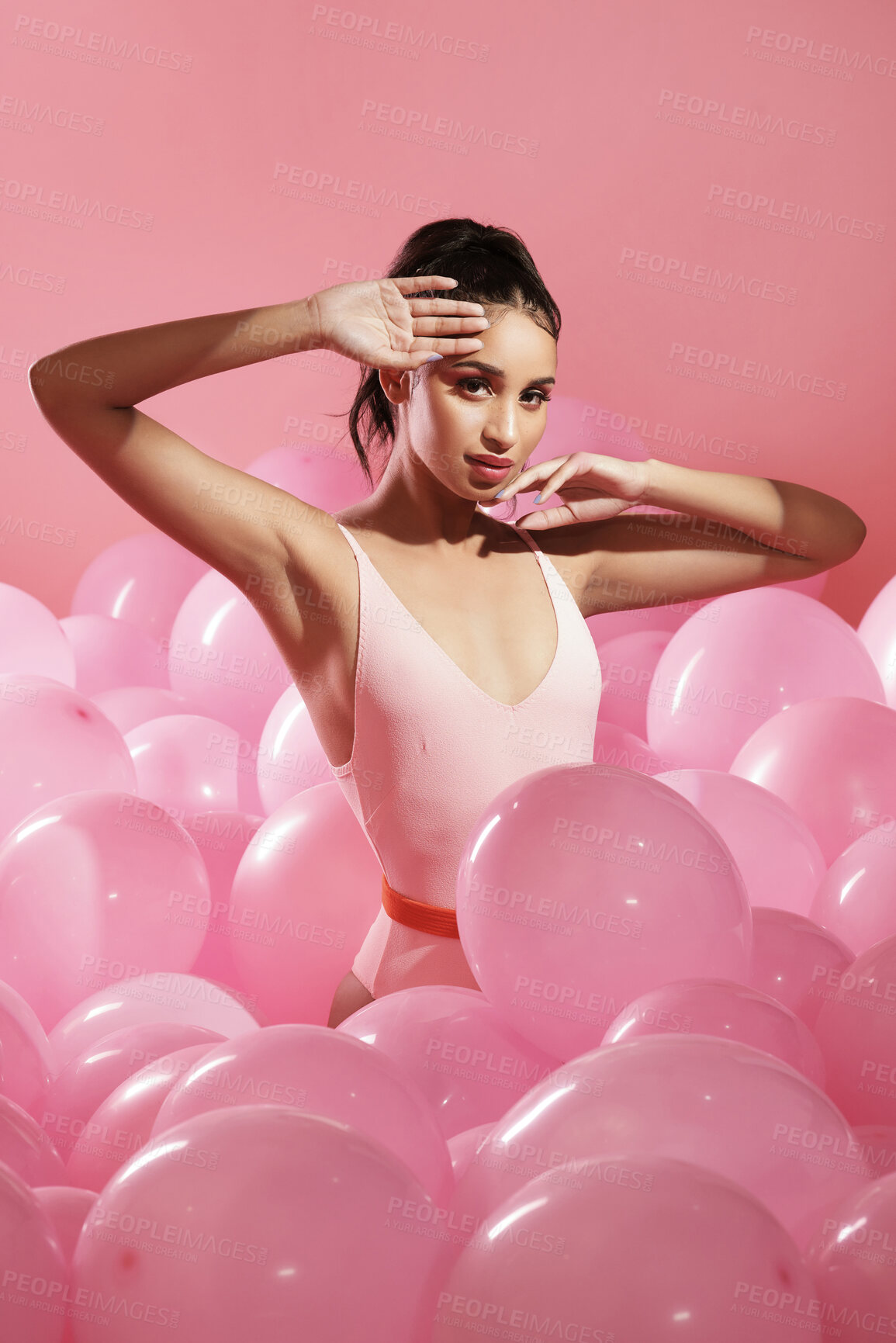 Buy stock photo Studio shot of a beautiful young woman posing with balloons