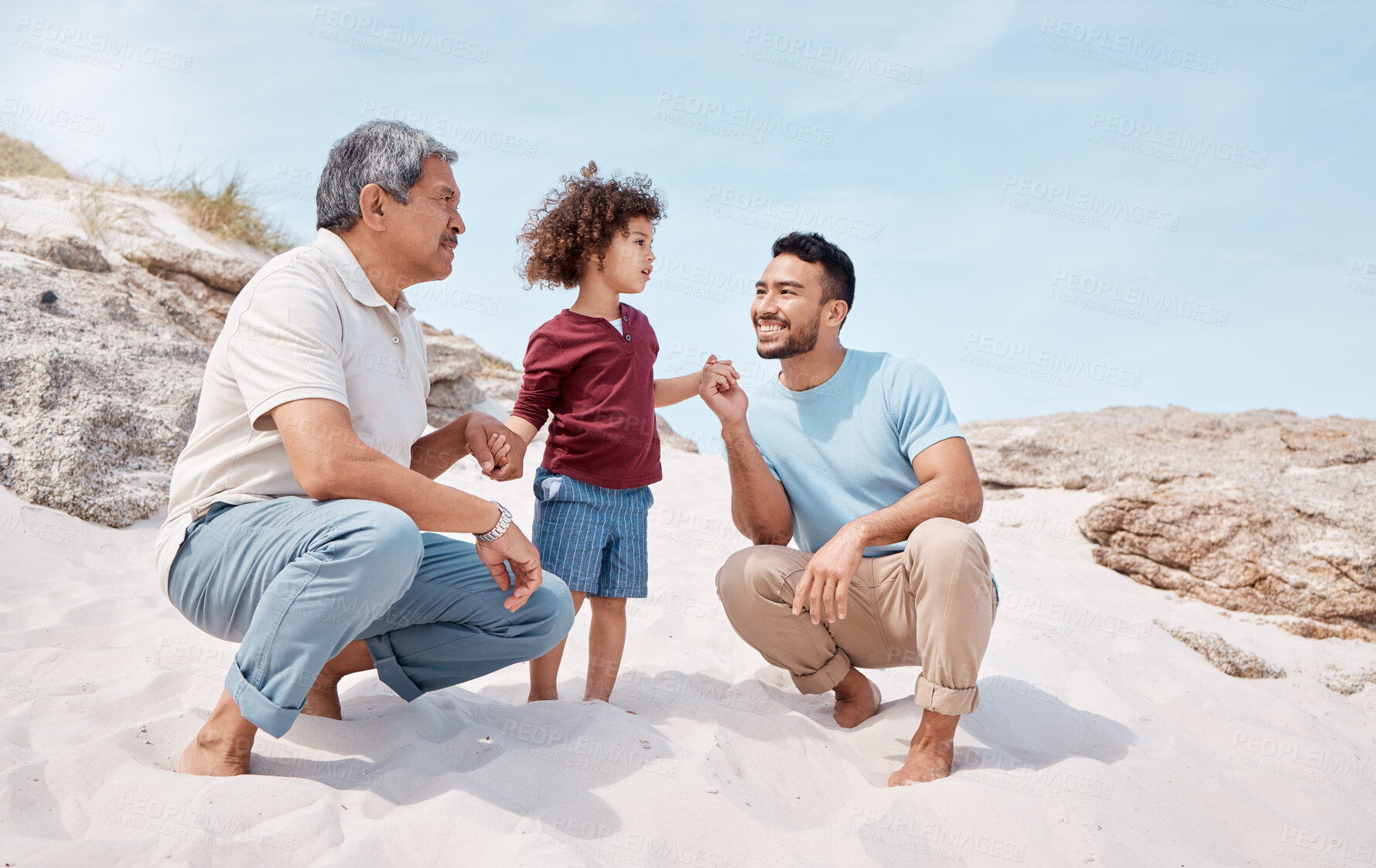 Buy stock photo Holding hands, smile and love with family at beach for bonding, summer vacation or support. Connection, generations and holiday with grandfather, man and child for weekend break, travel and trust