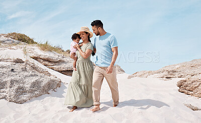 Buy stock photo Shot of a young couple at the beach with their child