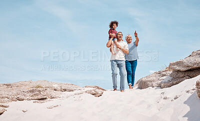 Buy stock photo Shot of an adorable little boy at the beach with his grandparents