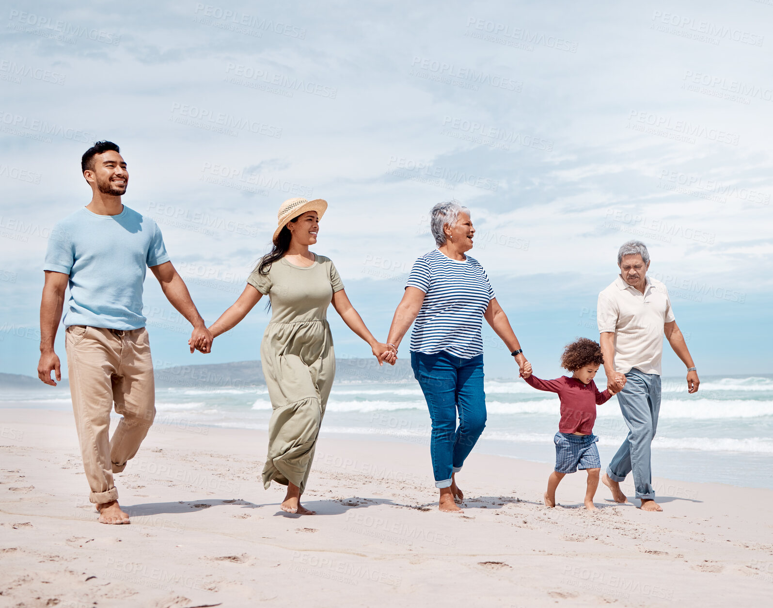 Buy stock photo Shot of a multi-generational family spending the day at the beach