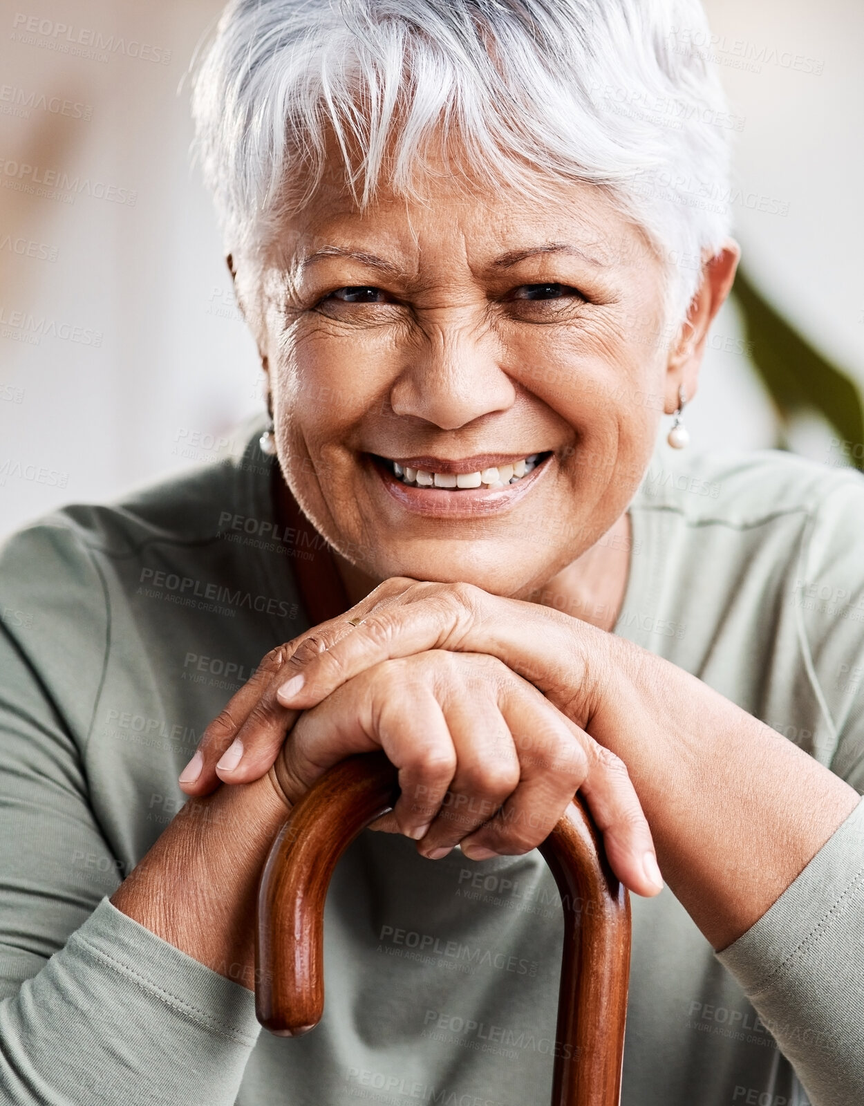 Buy stock photo Shot of a senior woman leaning in her walking stick at home