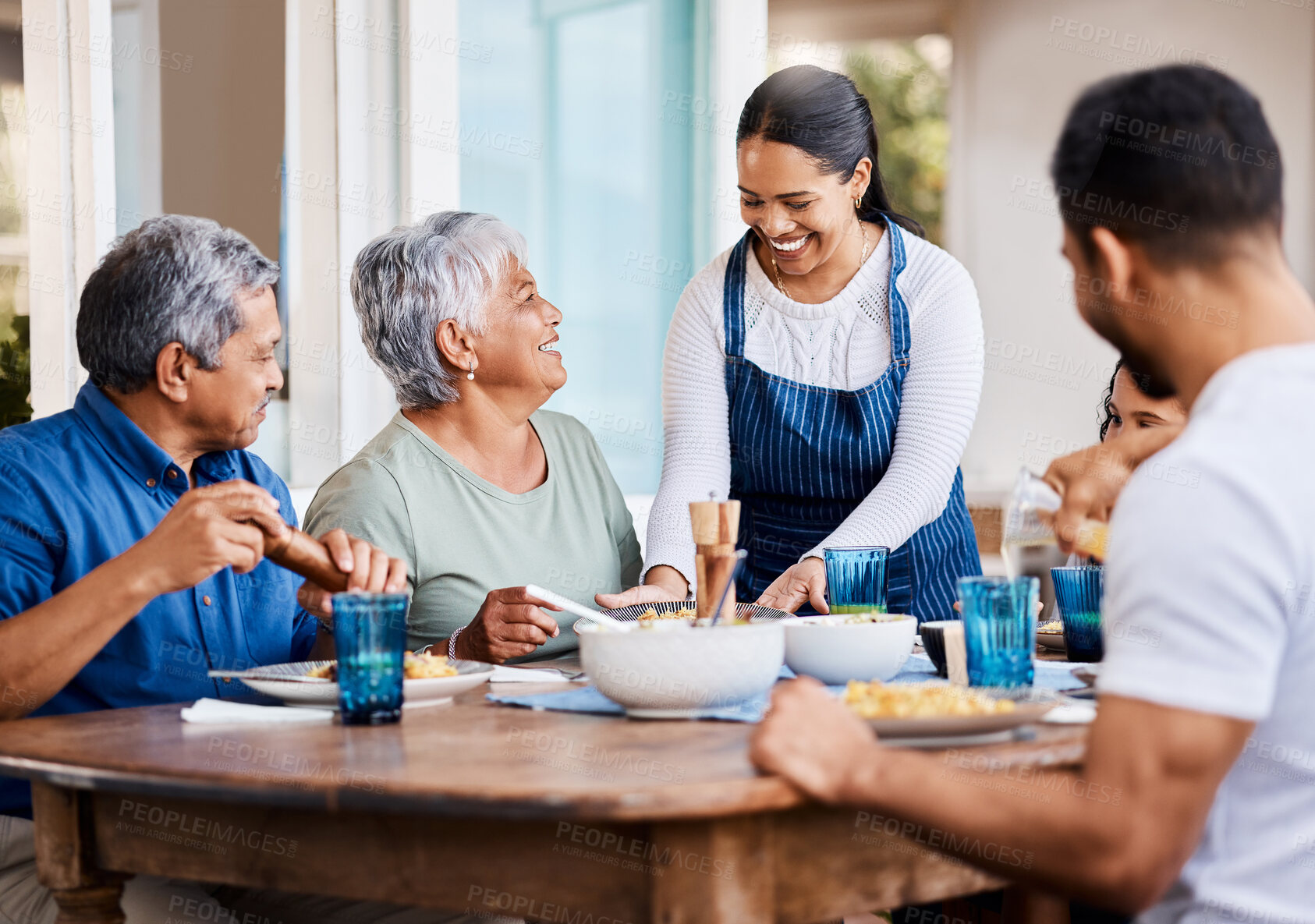 Buy stock photo Shot of a happy family having lunch together at home