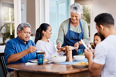 Buy stock photo Shot of a happy family having lunch together at home