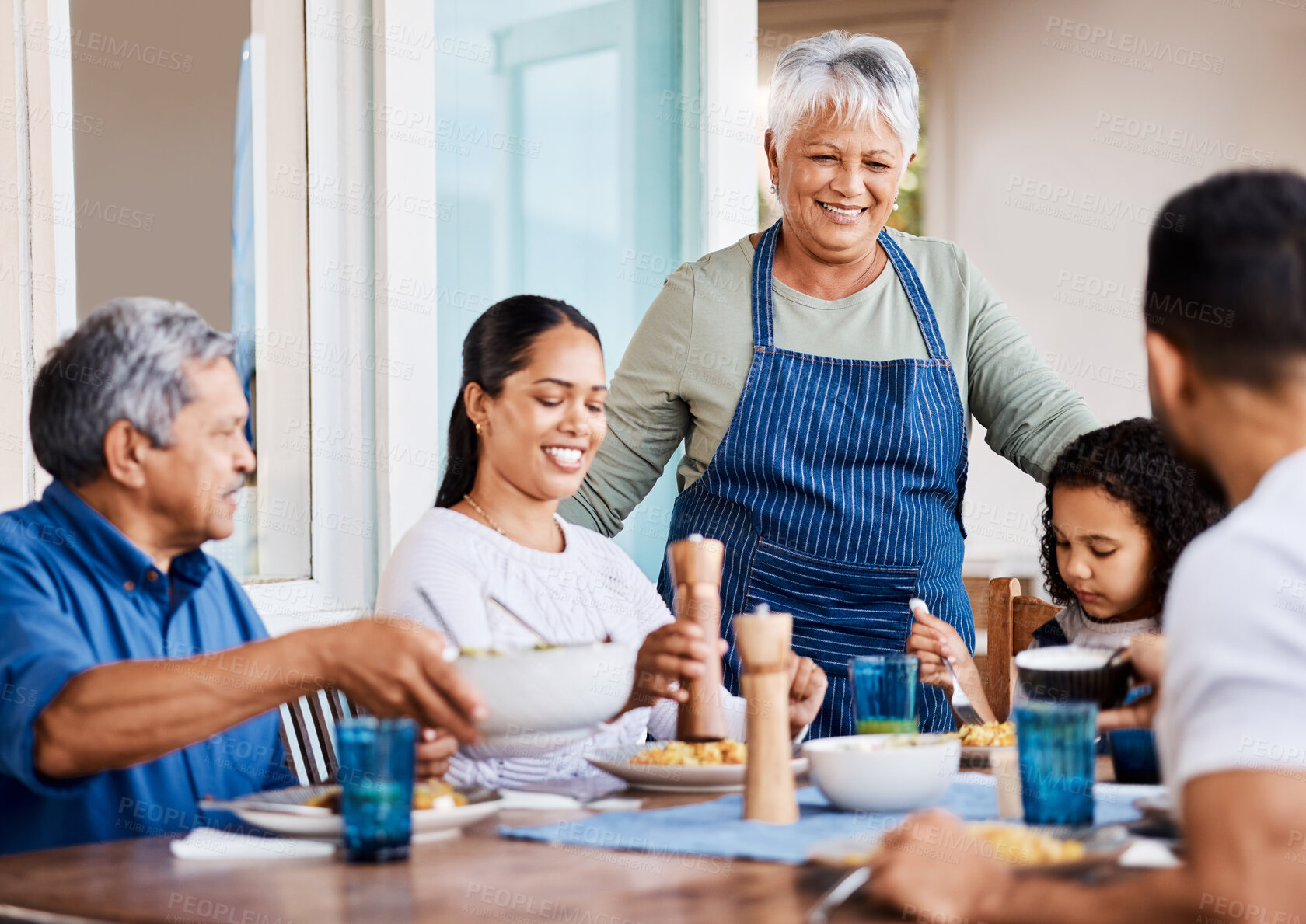 Buy stock photo Shot of a happy family having lunch together at home