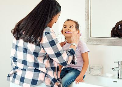 Buy stock photo Brushing teeth, dental and love of mother and daughter in bathroom of home for hygiene together. Cleaning, smile or mouth with single parent woman and girl child in apartment for morning routine