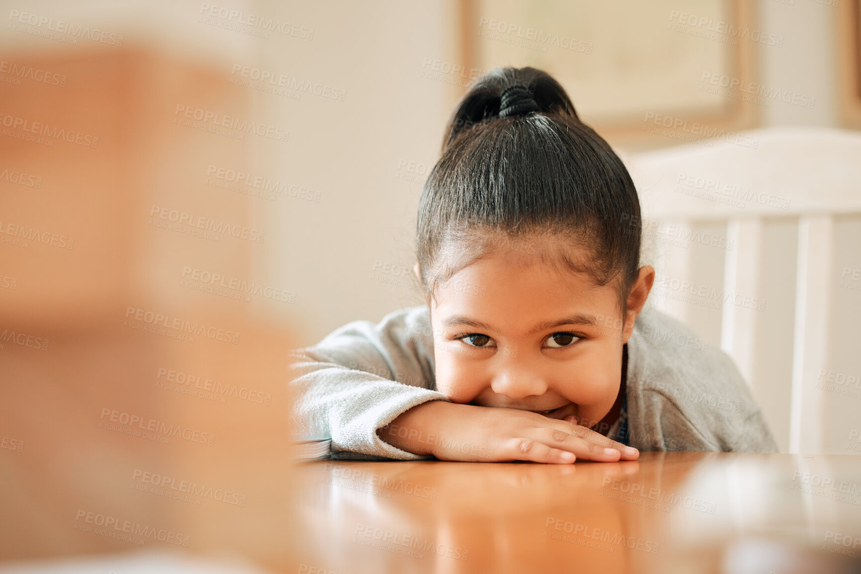 Buy stock photo Girl, kid and relax by table with portrait in home on weekend break, cute and shy with adorable face. Female child, smile and head on counter in house for playful, carefree and childhood fun or joy.