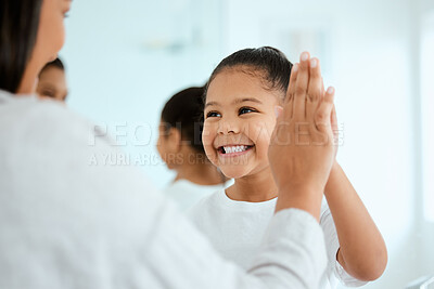 Buy stock photo Shot of an adorable little girl high fiving her mom at home