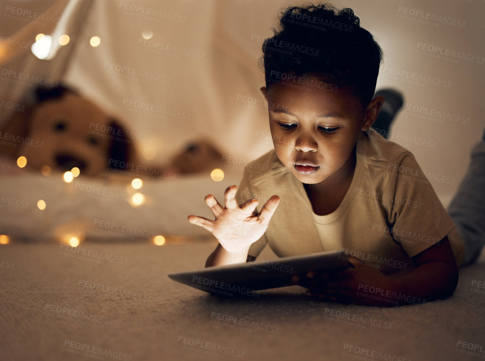 Buy stock photo Home, night and girl with tablet, bed and relax with internet, connection and ebook with story. Apartment, bedtime and happy kid with technology, evening and childhood with digital app, dark and rest