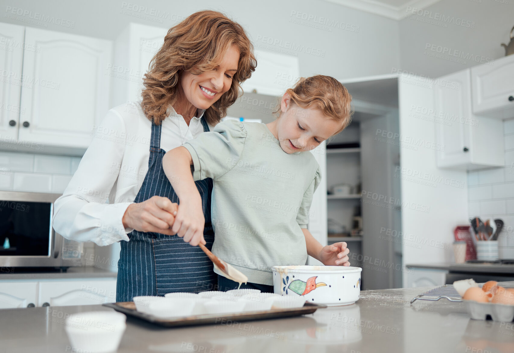 Buy stock photo Grandmother, help and girl baker for learning in kitchen, house or home for pastry or mixing cake dessert. Happy smile, bonding and cooking child teaching baking pudding, cookies or bakery recipe