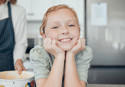 Buy stock photo Portrait of a little girl baking with her grandmother at home