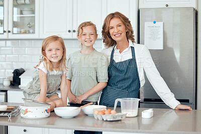 Buy stock photo Portrait of a grandmother baking with her two granddaughters at home