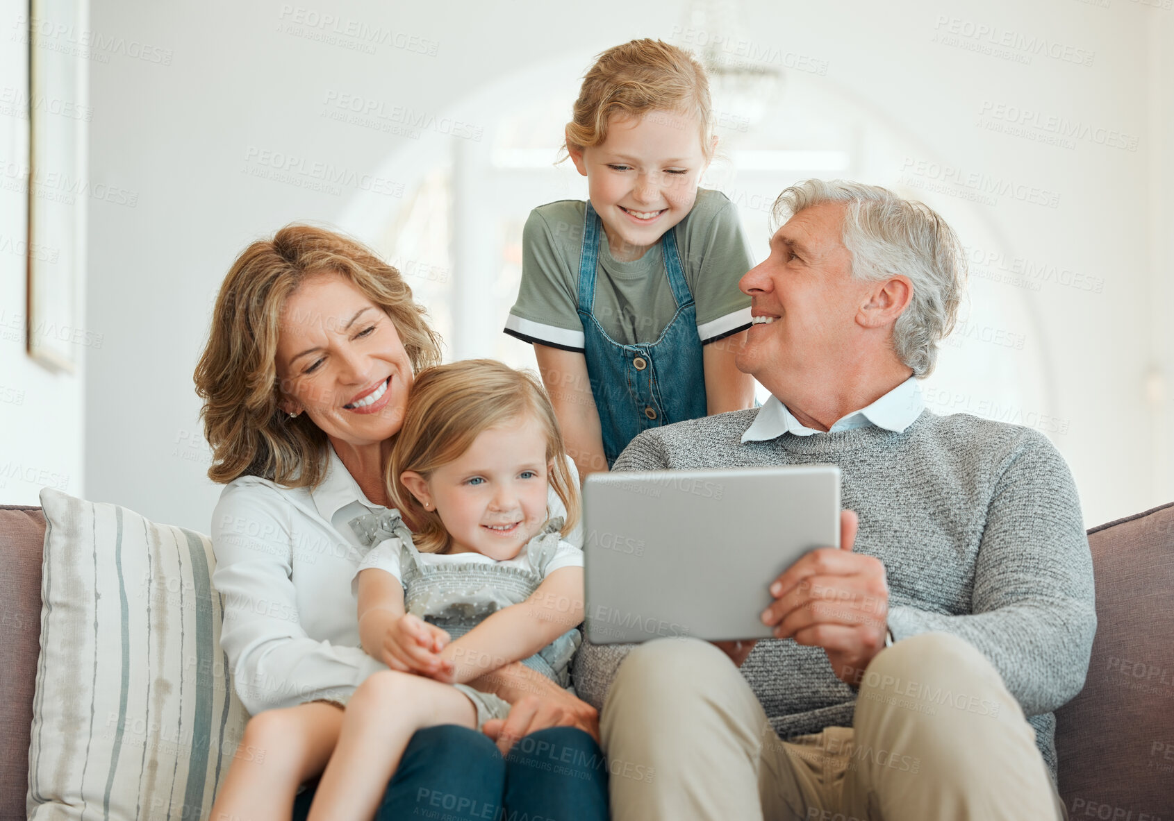 Buy stock photo Grandparents, tablet and kids with movie streaming, internet learning and youth game with generations. Happy, smile and bonding from comedy show watching on website with tech and love from family