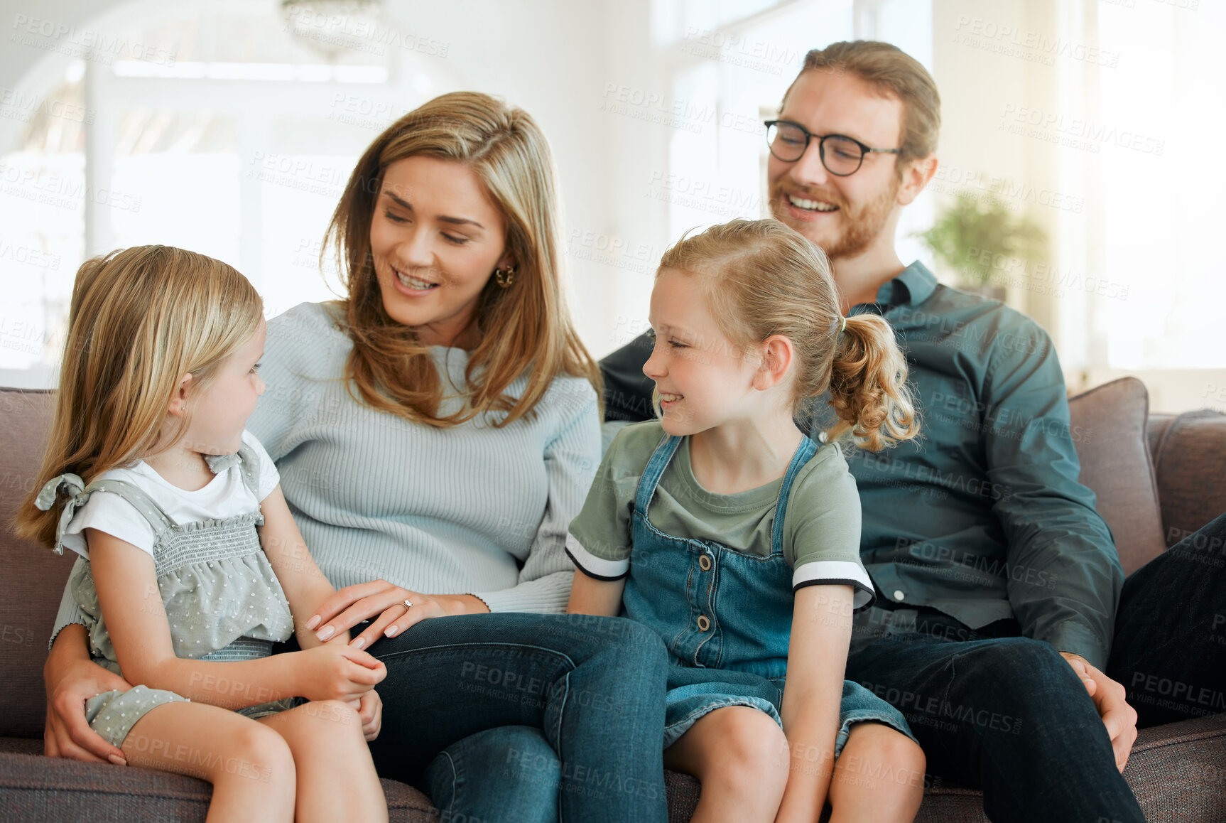 Buy stock photo Conversation, love and relax with family on sofa in living room of home for bonding together. Happy, smile or talking with mother, father and girl children in apartment for development or growth