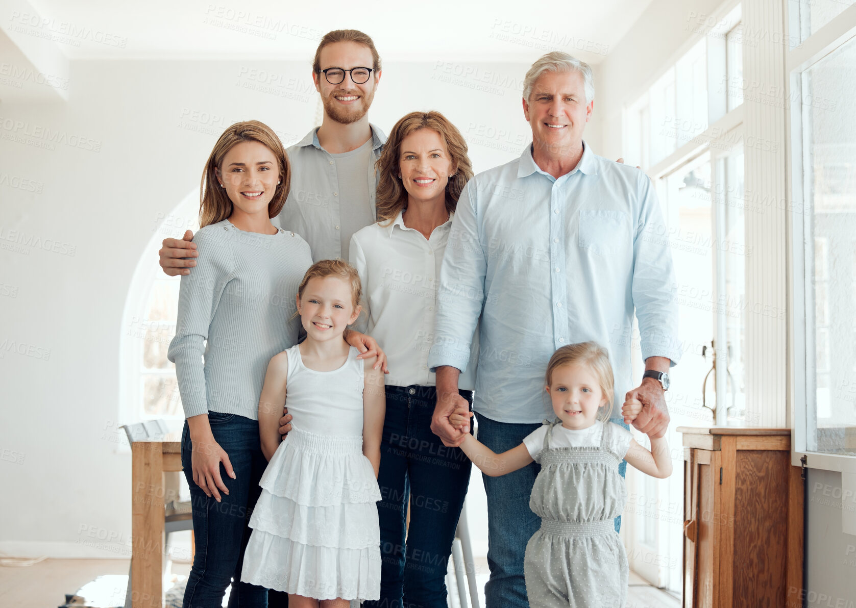 Buy stock photo Holding hands, portrait and smile of big family in home together for bonding, love or visit. Retirement, security or trust with happy senior people, parents and children in apartment for safety