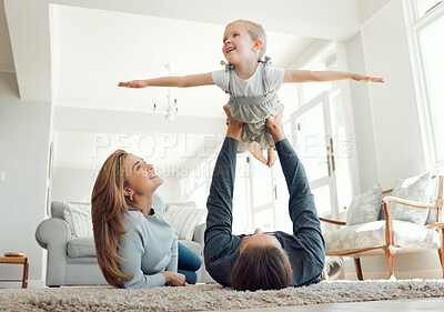 Buy stock photo Shot of a family bonding playfully on the lounge floor together