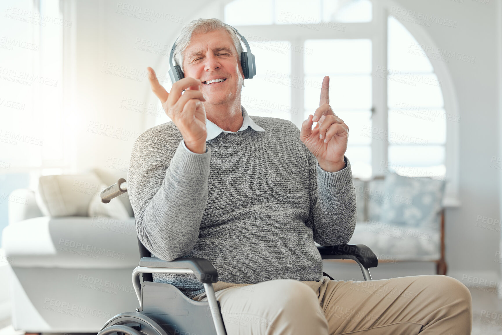 Buy stock photo Music, retirement and wheelchair with senior man in living room of home for break or relax. Headphones, audio or wellness and smile of old person with disability in apartment for radio streaming