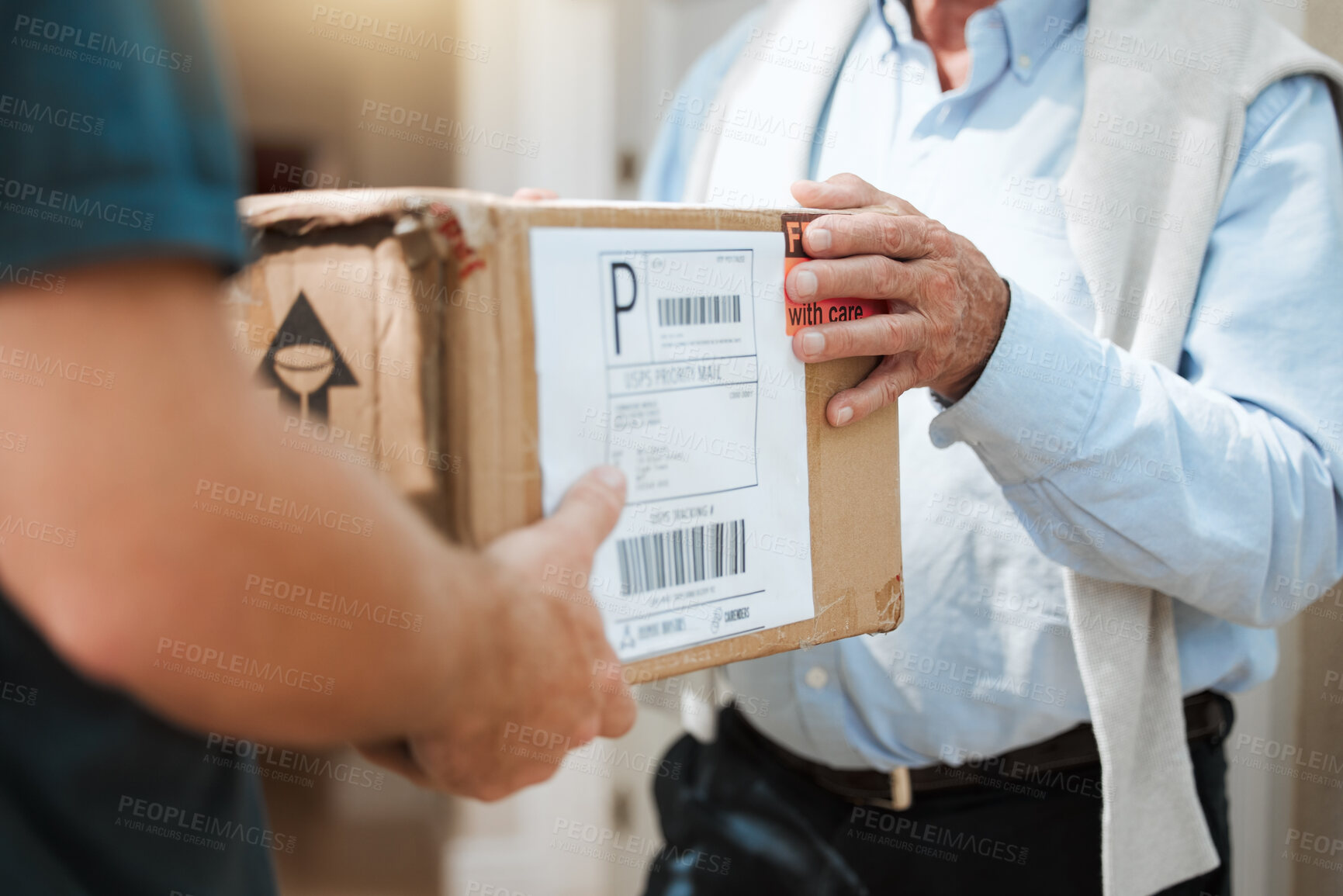 Buy stock photo Closeup shot of an unrecognisable man making a delivery to a customer at their home