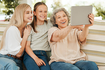 Buy stock photo Shot of a grandmother spending time with her daughter and granddaughter while using a digital tablet