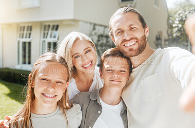 Buy stock photo Shot of a couple and their two children standing together outside