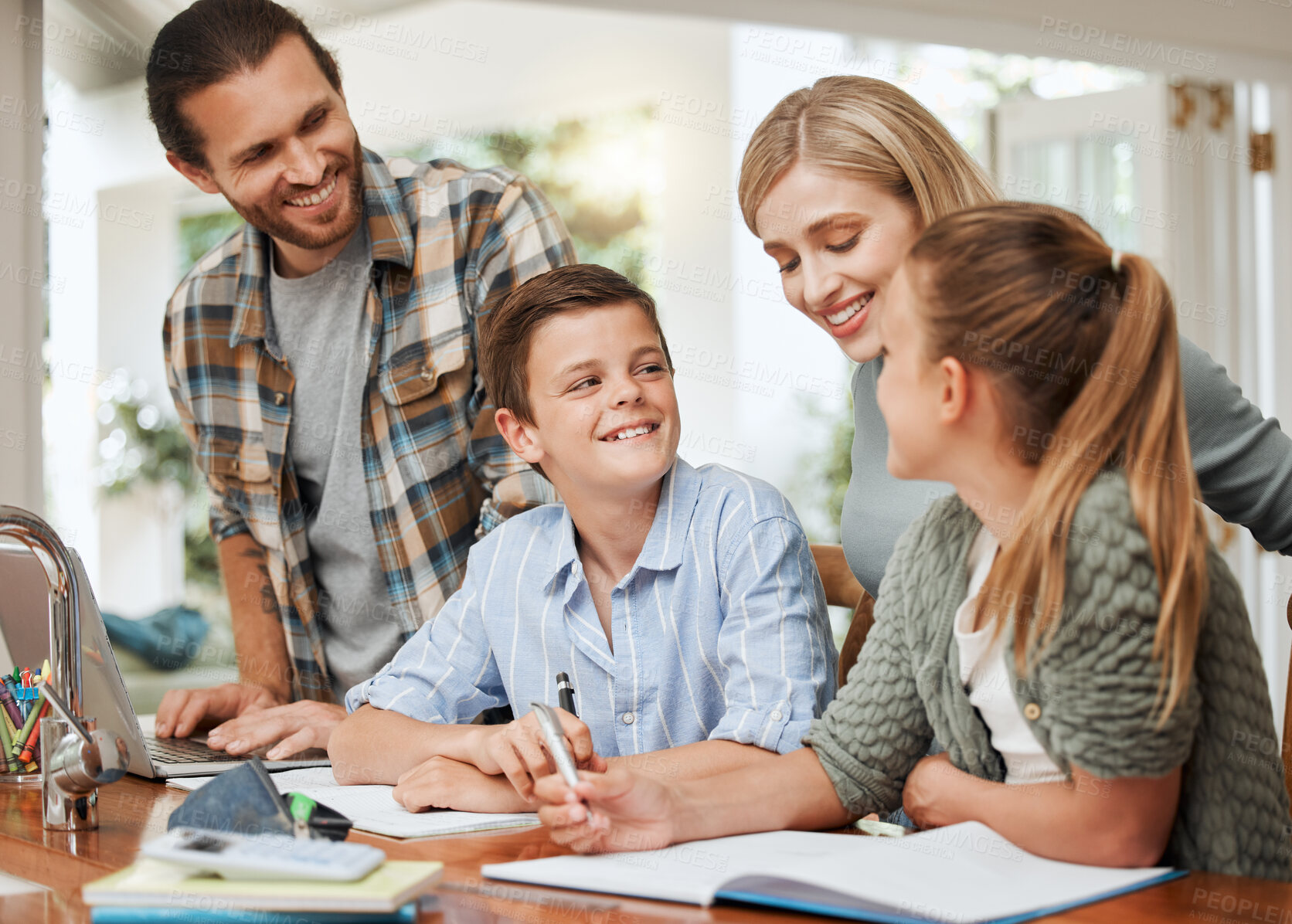 Buy stock photo Shot of a young family doing homework together at home