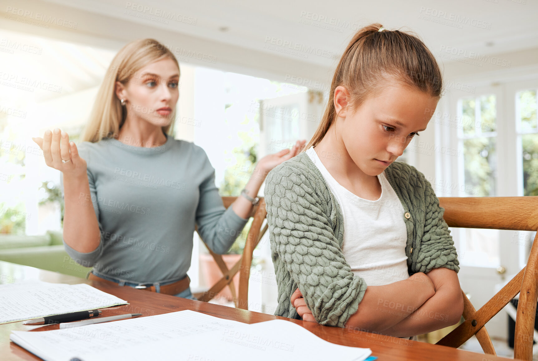 Buy stock photo Frustrated mother, homework and behaviour with child, adhd or struggle in education or learning at home. Angry mom, teenager or kid in stress with school books, stubborn attitude or tantrum at house