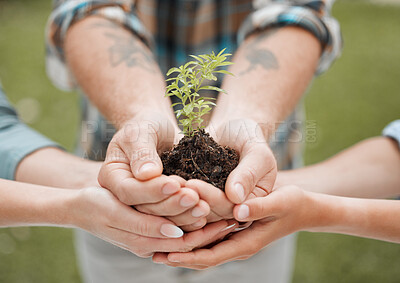 Buy stock photo Shot of a unrecognisable person holding a plant growing out of soil