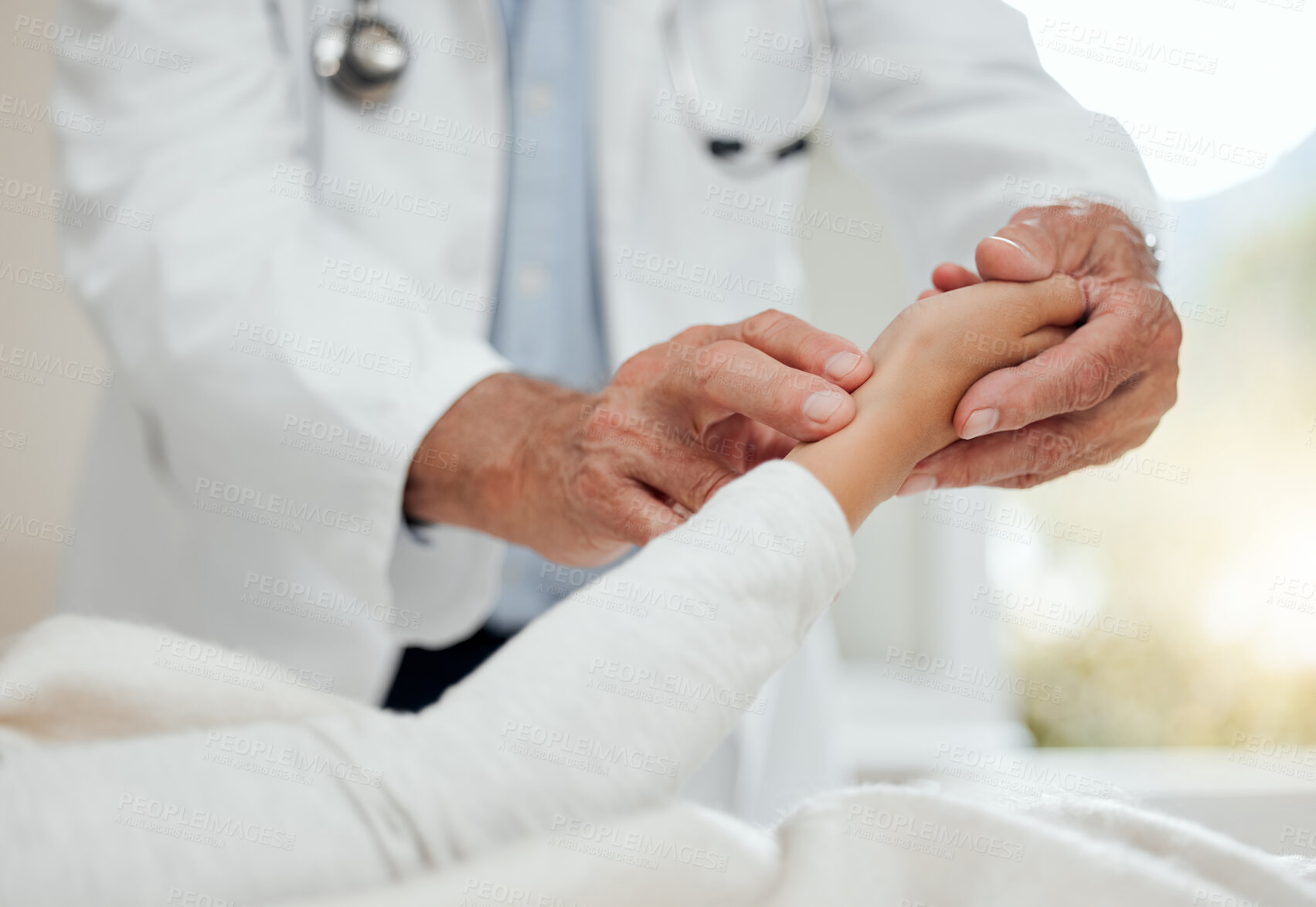 Buy stock photo Shot of a unrecognizable doctor checking a patient's wrist at home office