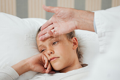 Buy stock photo Shot of an unrecognizable doctor checking a sick little girl's temperature at home