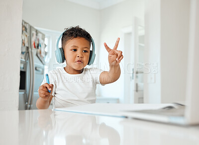 Buy stock photo Shot of a little boy doing his homework at home