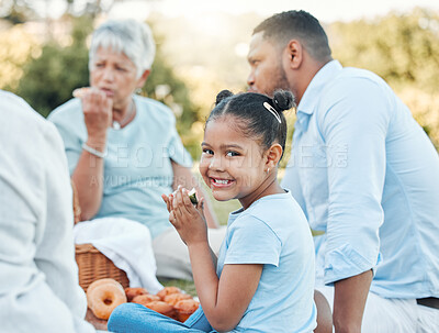 Buy stock photo Shot of a little girl enjoying a picnic with her family