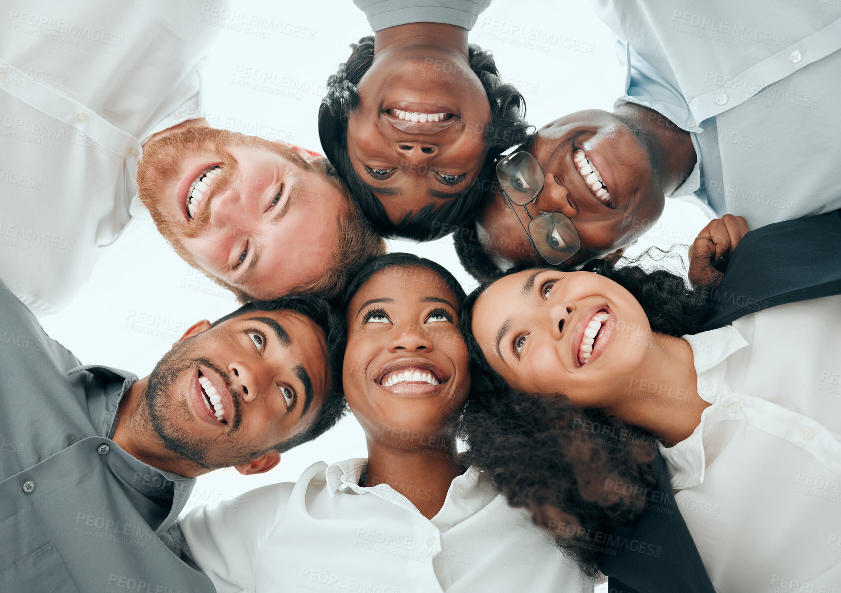 Buy stock photo Low angle shot of a diverse group of young businesspeople standing in a huddle in the office