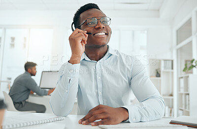 Buy stock photo Cropped shot of a handsome young male call center agent working at his desk in the office