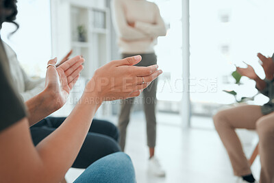 Buy stock photo Cropped shot of an unrecognisable group of people sitting together and clapping during group therapy