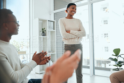 Buy stock photo Shot of an attractive young woman standing while her support group celebrate her success