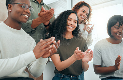 Buy stock photo Shot of a diverse group of people sitting together and clapping during group therapy