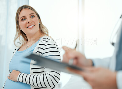 Buy stock photo Shot of a doctor during a consultation with a pregnant patient in a clinic