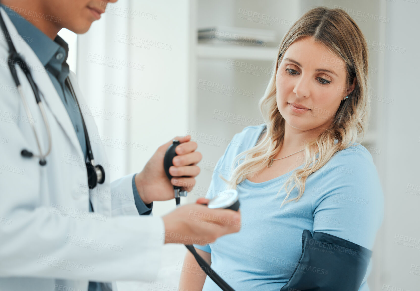 Buy stock photo Clinic, pregnant woman and doctor with checkup for blood pressure, monitor heart rate and appointment. Healthcare, patient and obstetrician with consultation for pregnancy, hypertension and wellness