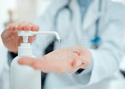 Buy stock photo Cropped shot of an unrecognisable doctor using hand sanitiser in her clinic