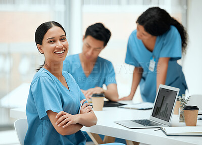 Buy stock photo Shot of a young female doctor using a laptop while working at a hospital