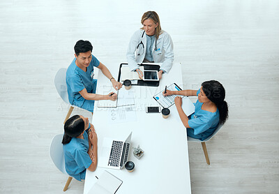 Buy stock photo High angle shot of a group of doctors having a meeting at a hospital