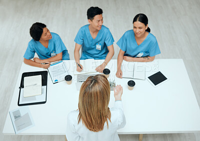 Buy stock photo High angle shot of a group of doctors having a meeting
