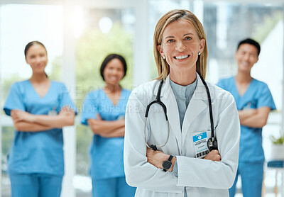 Buy stock photo Portrait, team and a doctor woman arms crossed, standing in the hospital for healthcare or medicine. Leadership, medical or teamwork with a mature female health professional in a clinic for treatment